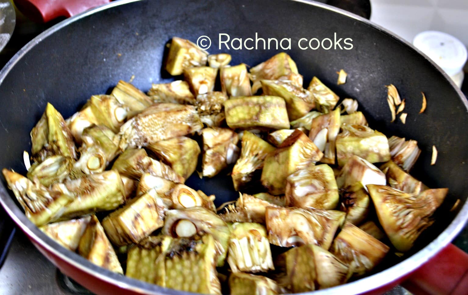 Sauteeing raw jackfruit pieces in a kadhai
