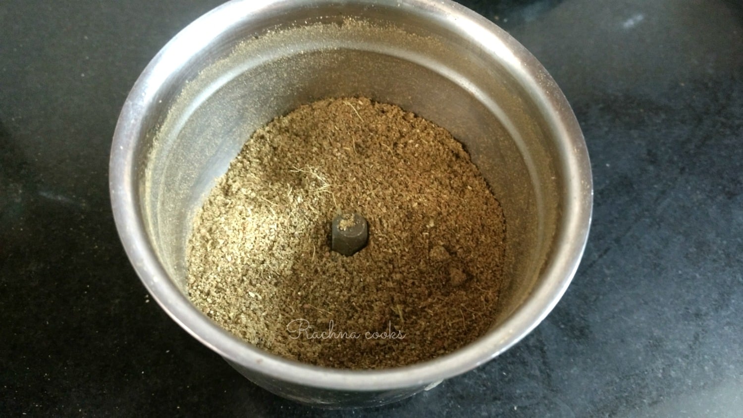 Garam masala powder after blending in a blender jar.