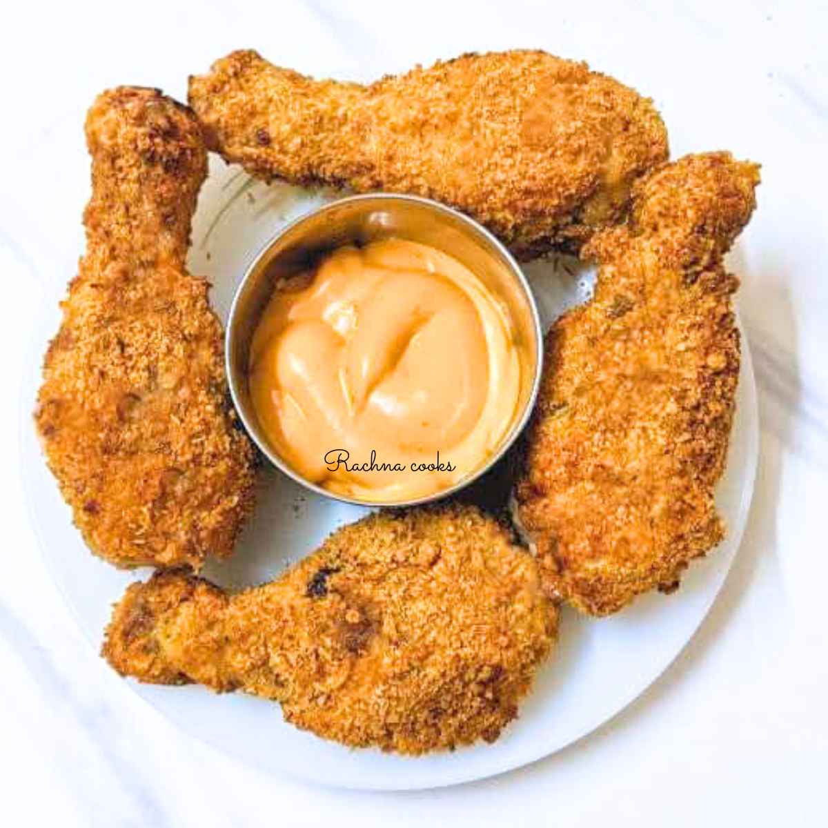 4 fried chicken drumsticks with dip in the center