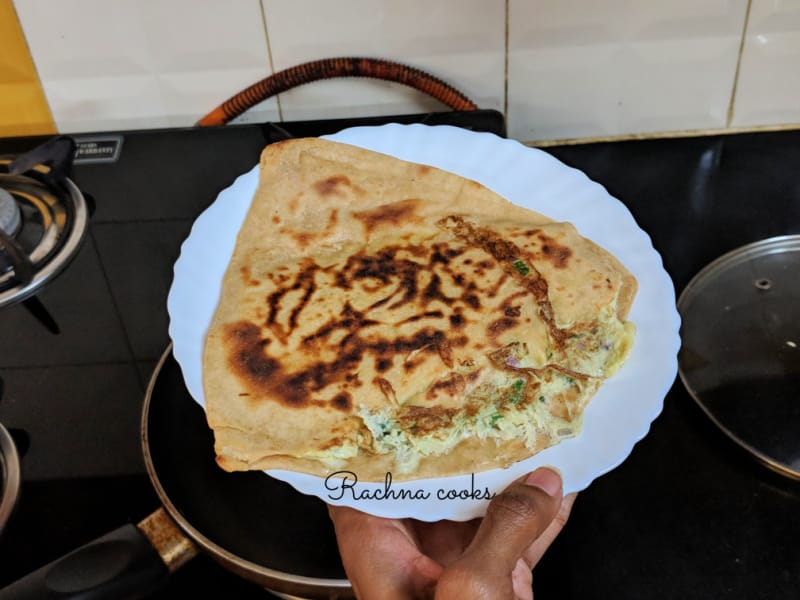 Egg paratha served on a white plate.