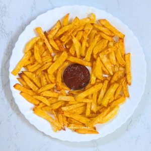 French fries served with ketchup on white plate