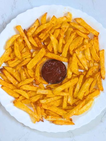 French fries served with ketchup on white plate