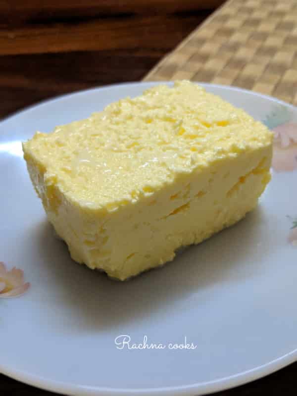 A block of churned butter on a white plate.