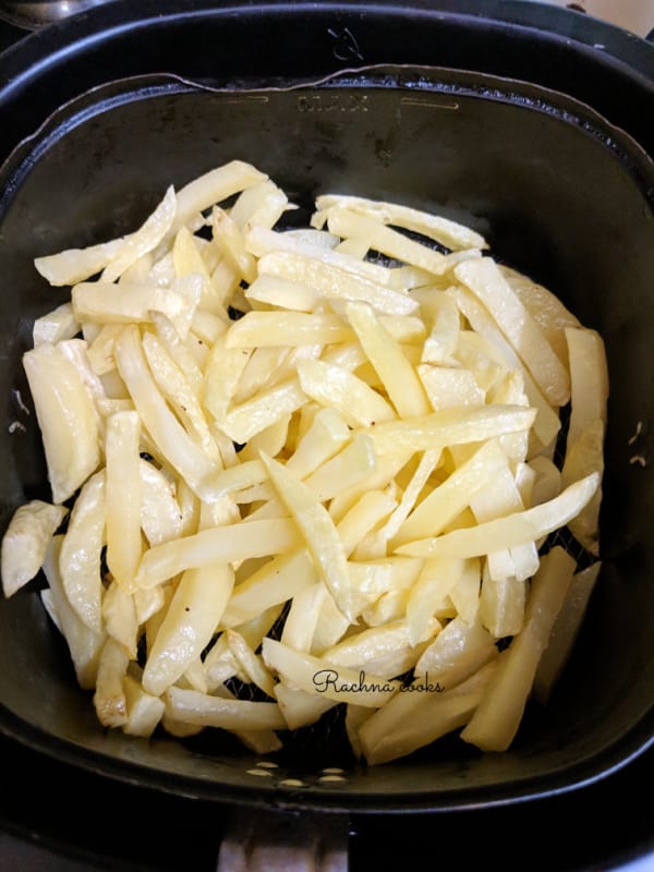 French fries being cooked in air fryer.