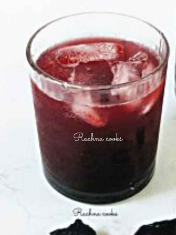 A glass of kokum sharbat served with ice cubes