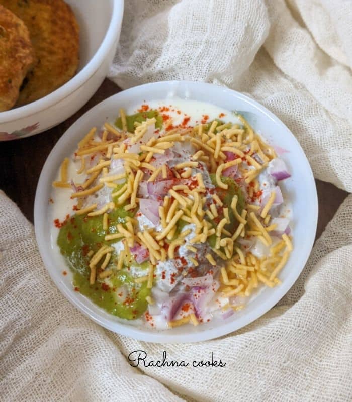 aloo tikki chaat in a white bowl.