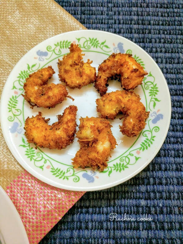 Delightful coconut shrimp shallow fried on a white plate