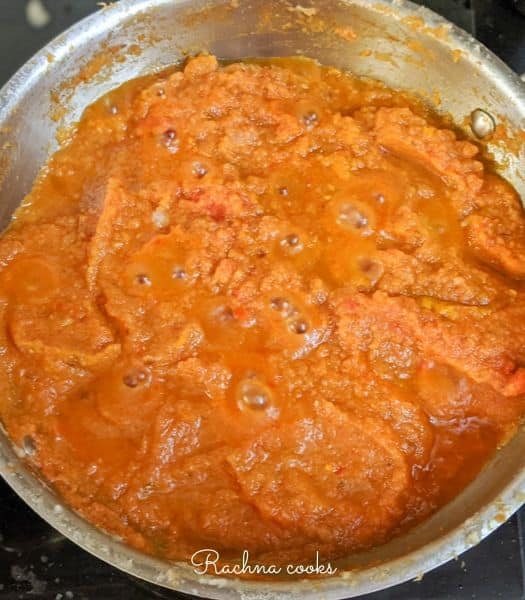 Bright curry paste in a large wok