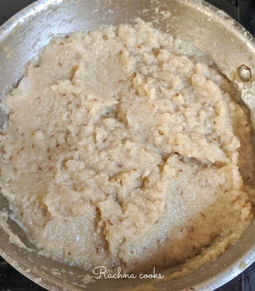 The curry base in a large wok is golden brown 