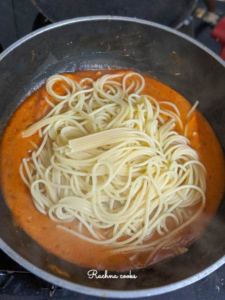 Cooked spaghetti tossed in the cooked pumpkin sauce.