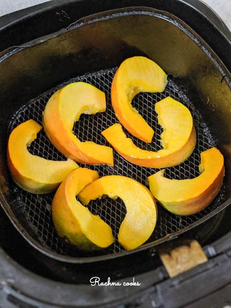 Pumpkin wedges in an Air fryer basket