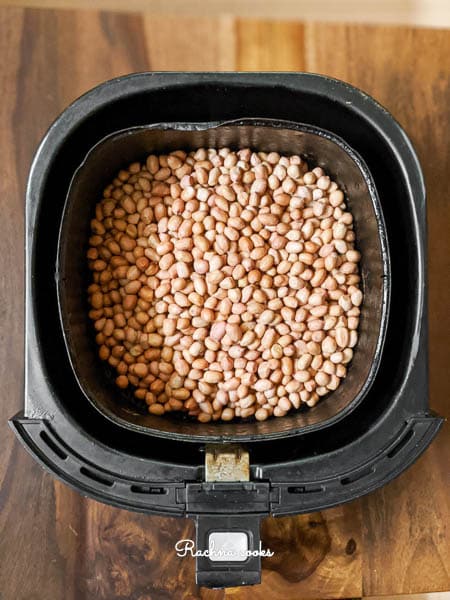 Peanuts in air fryer basket for roasting