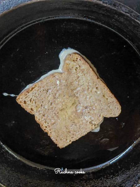a slice of french toast cooking in a skillet