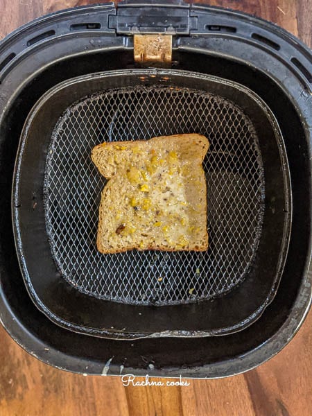 A slice of dipped bread in the Air fryer basket.