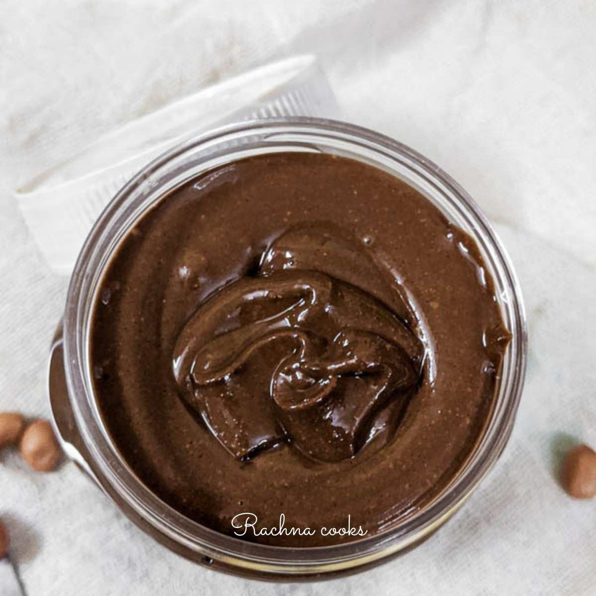 Top shot of open jar of shiny chocolate peanut butter