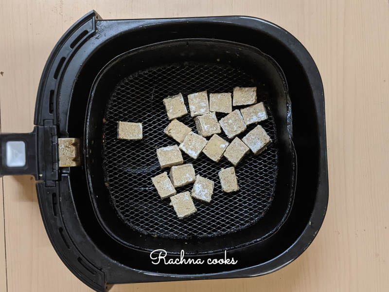 tofu cubes after air frying in air fryer basket