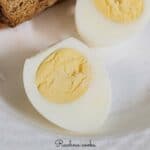 Boiled egg cut in half on a white background