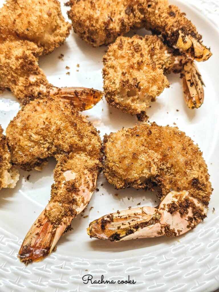 Close up of golden brown Air fried tempura shrimp on a white plate 