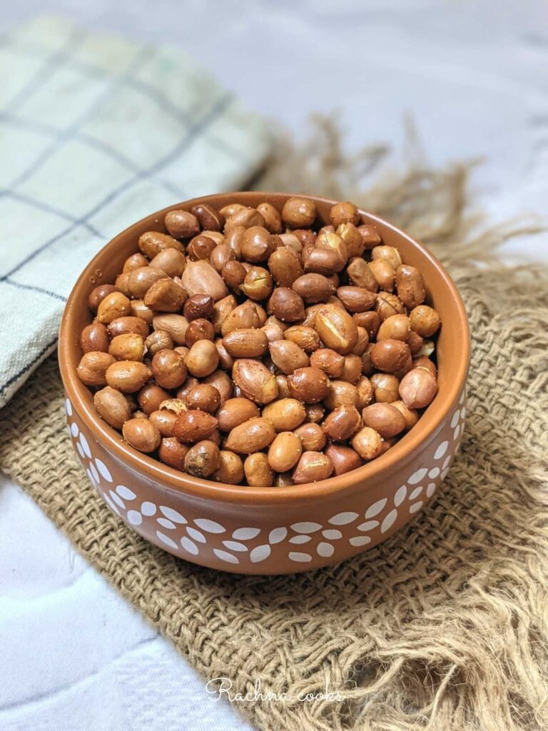 A bowl of roasted peanuts done in air fryer with a spicy coating.