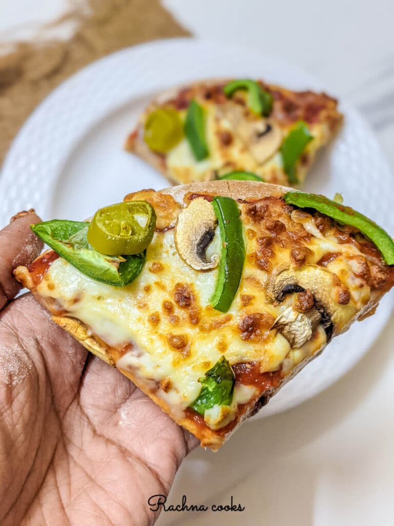 A slice of delicious air fryer pizza shown in closeup.
