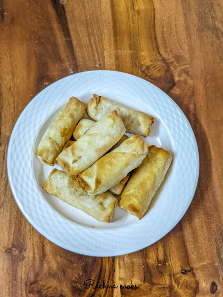 Air fried spring rolls on a white plate