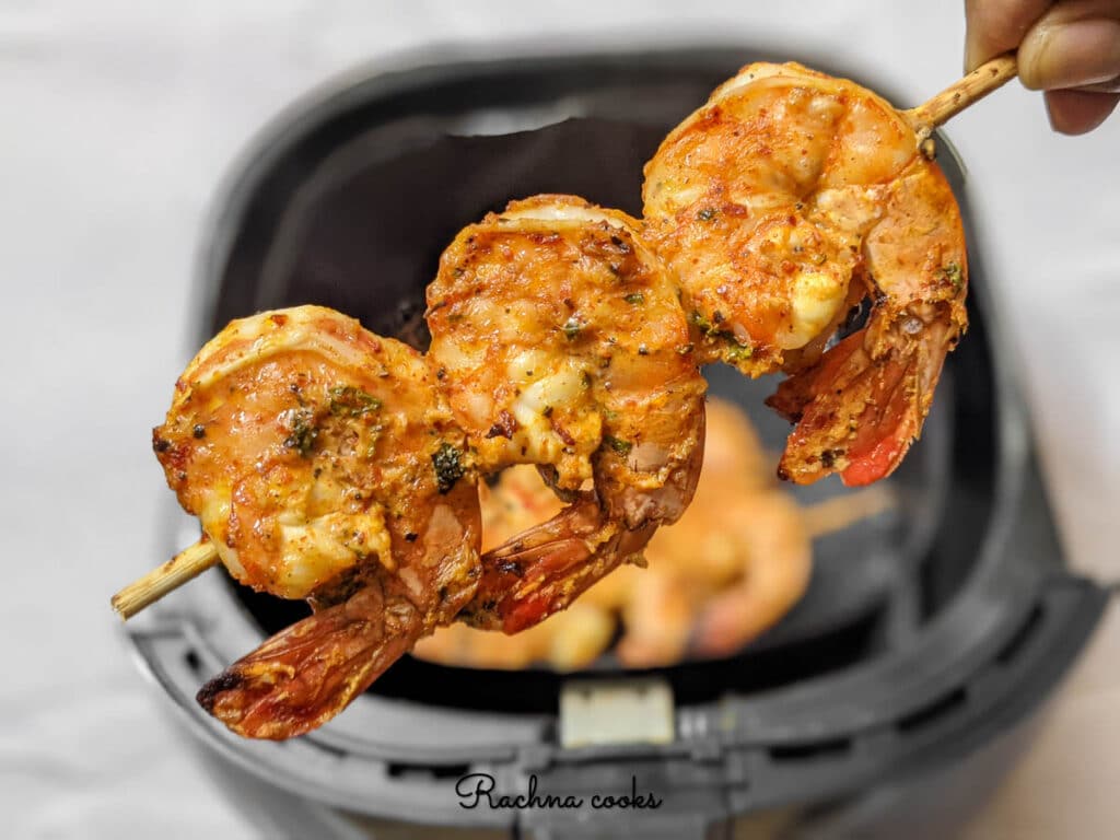 Delicious tandoori shrimp after air frying. A skewer of shrimp featured here.