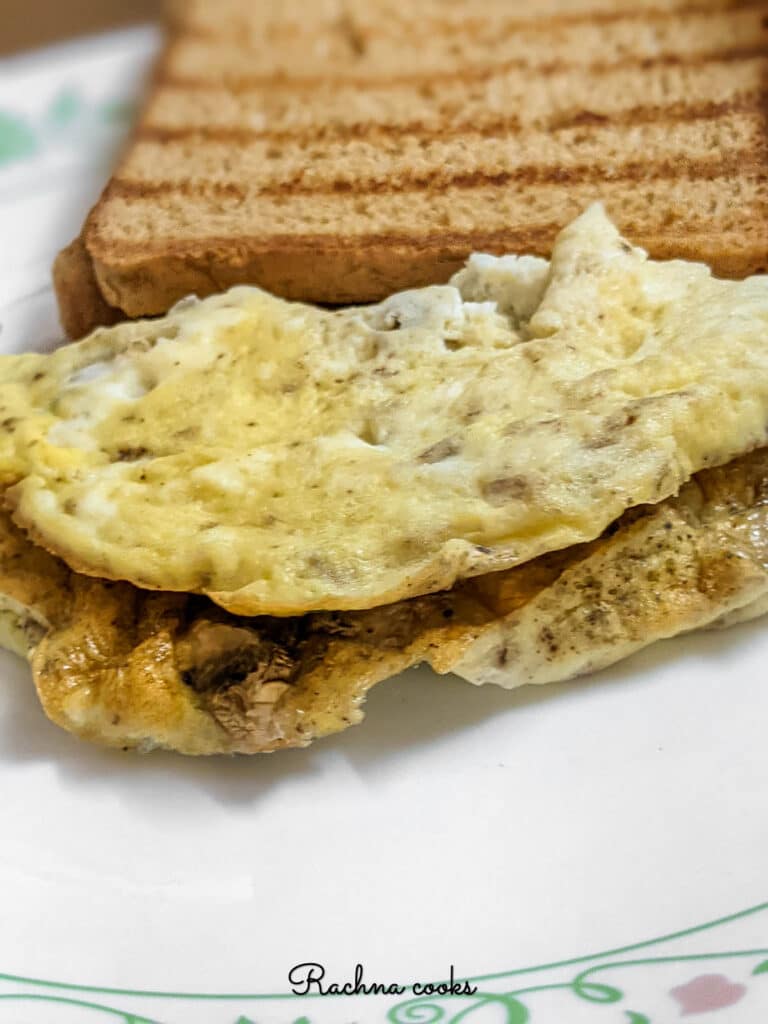 close up of air fryer omelet on a plate with toasted bread.