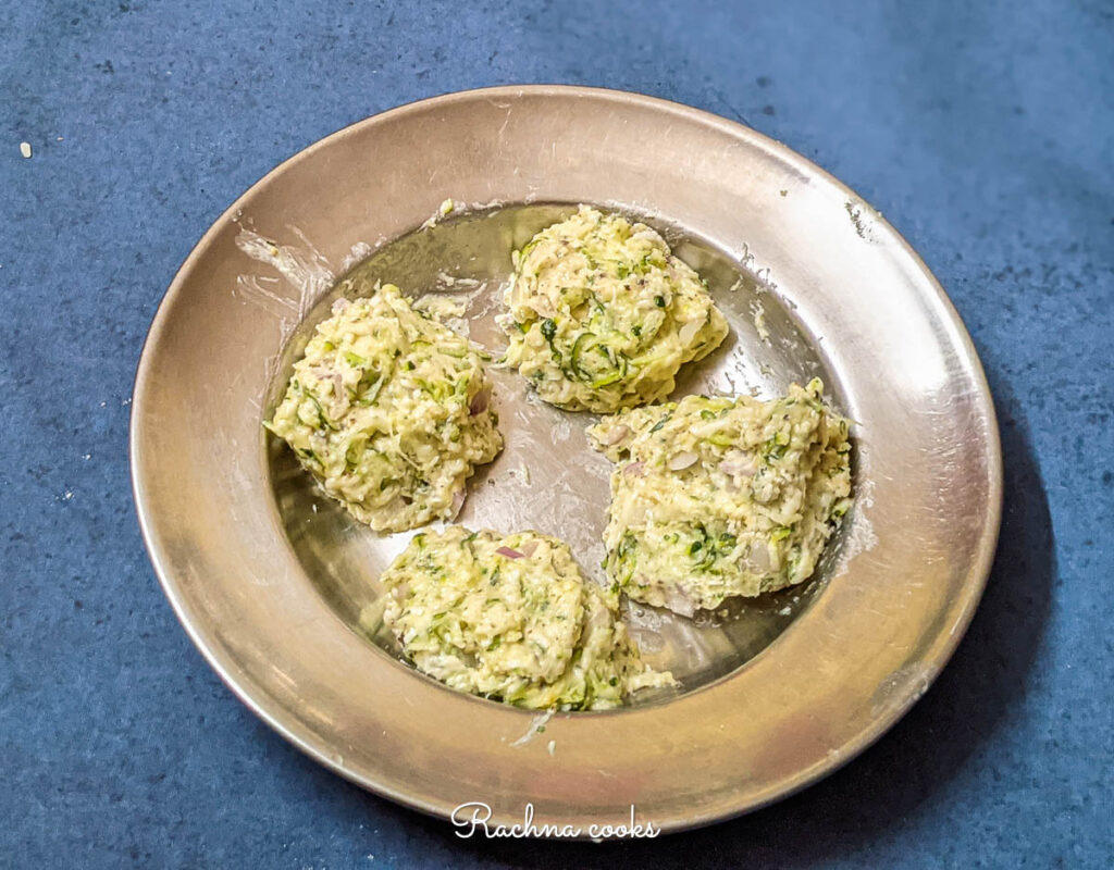 zucchini fritters ready for air frying kept in a plate