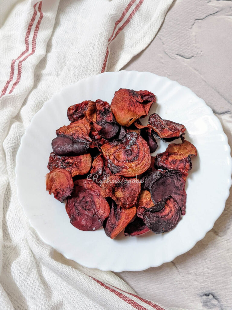 air fried beet chips on a white plate.
