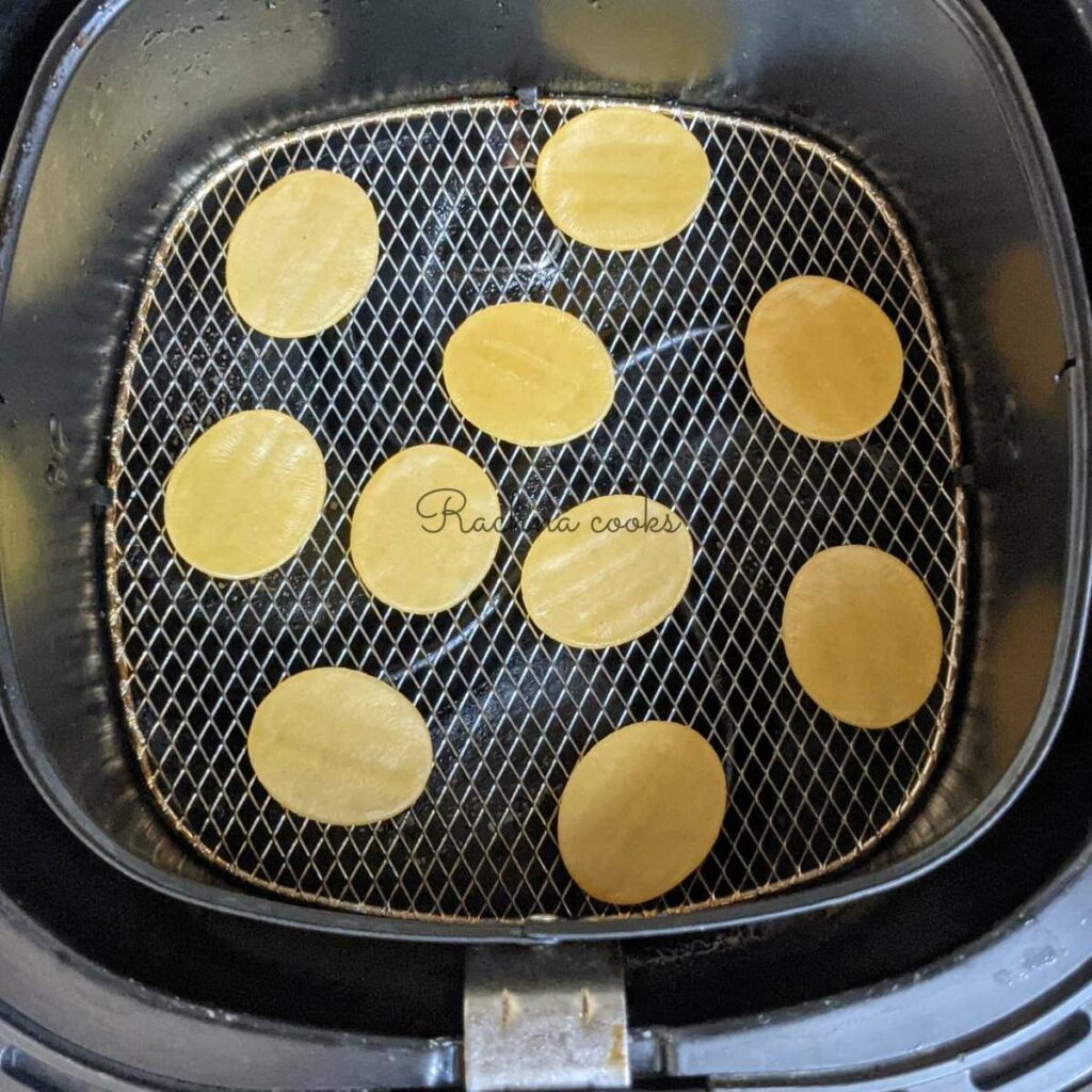 ready made puris in air fryer basket for air frying.