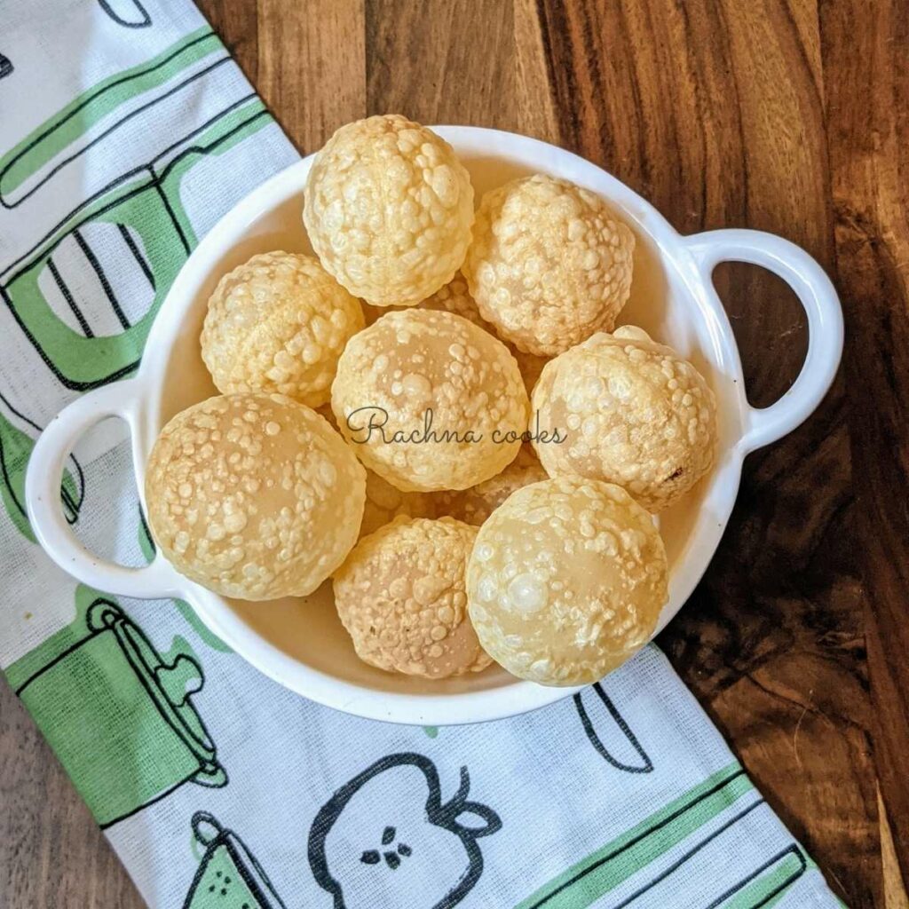 crispy puffed puris in a white bowl.