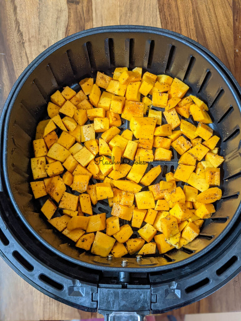 butternut squash in air fryer basket ready for air frying.