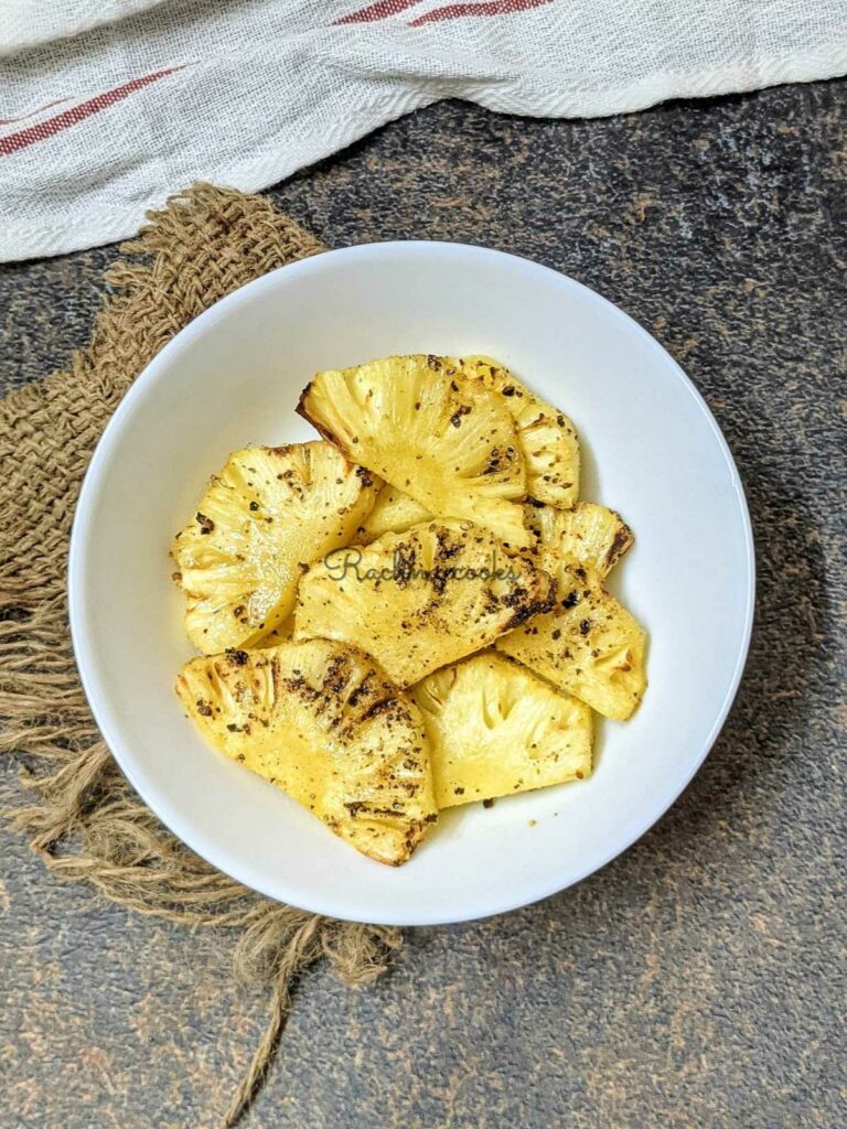 air fried pineapple slices in a white bowl with a brown background