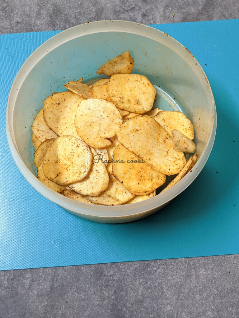 Sweet potato chips after sprinkling with oil and spices.