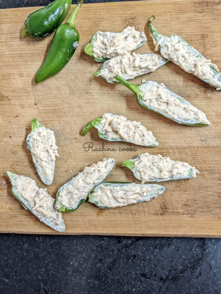 Stuffed jalapeno poppers on a chopping board