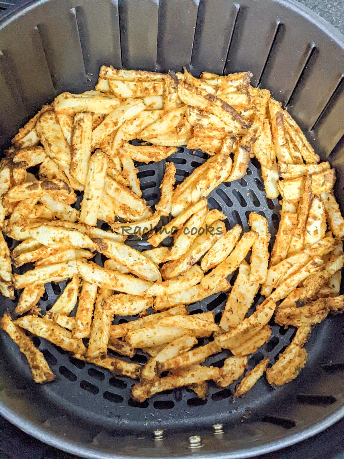 Turnip fries after air frying in the air fryer basket.