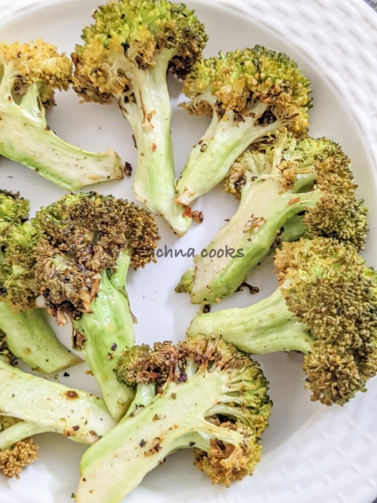 Closeup of a plate of roasted broccoli florets after air frying 