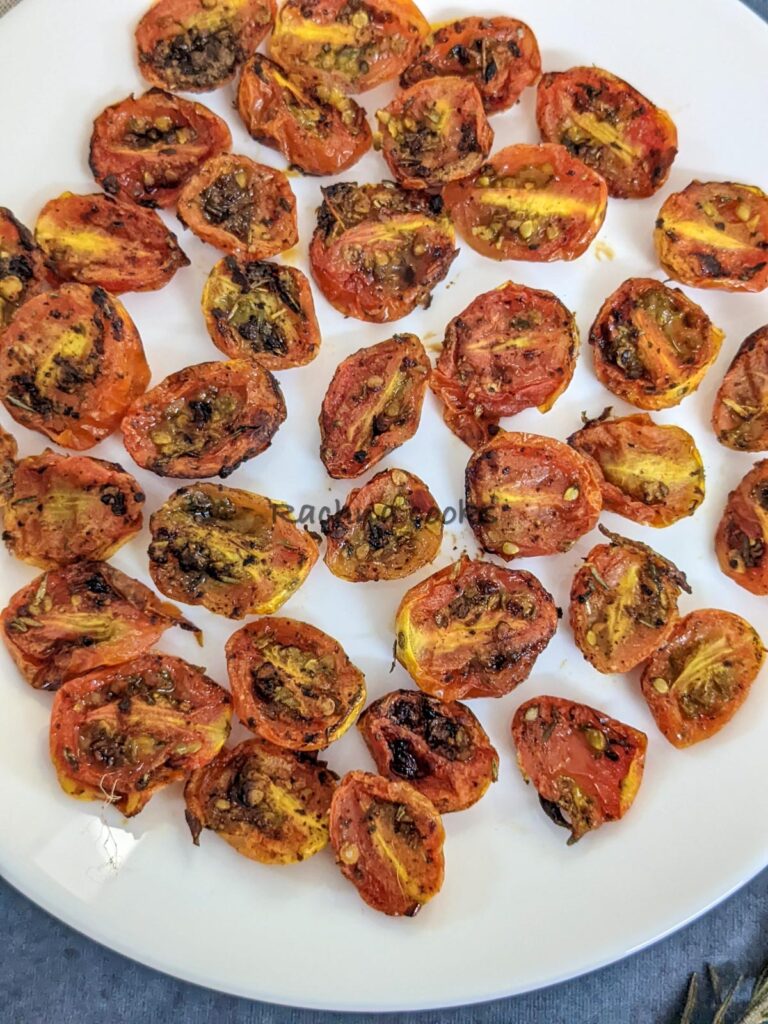 Close up of air fried cherry tomato halves on a plate.