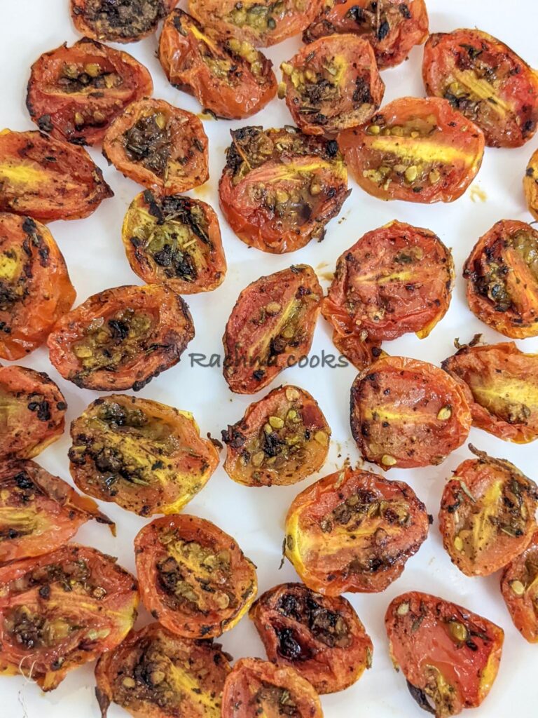Close up of air fried cherry tomato halves on a plate.