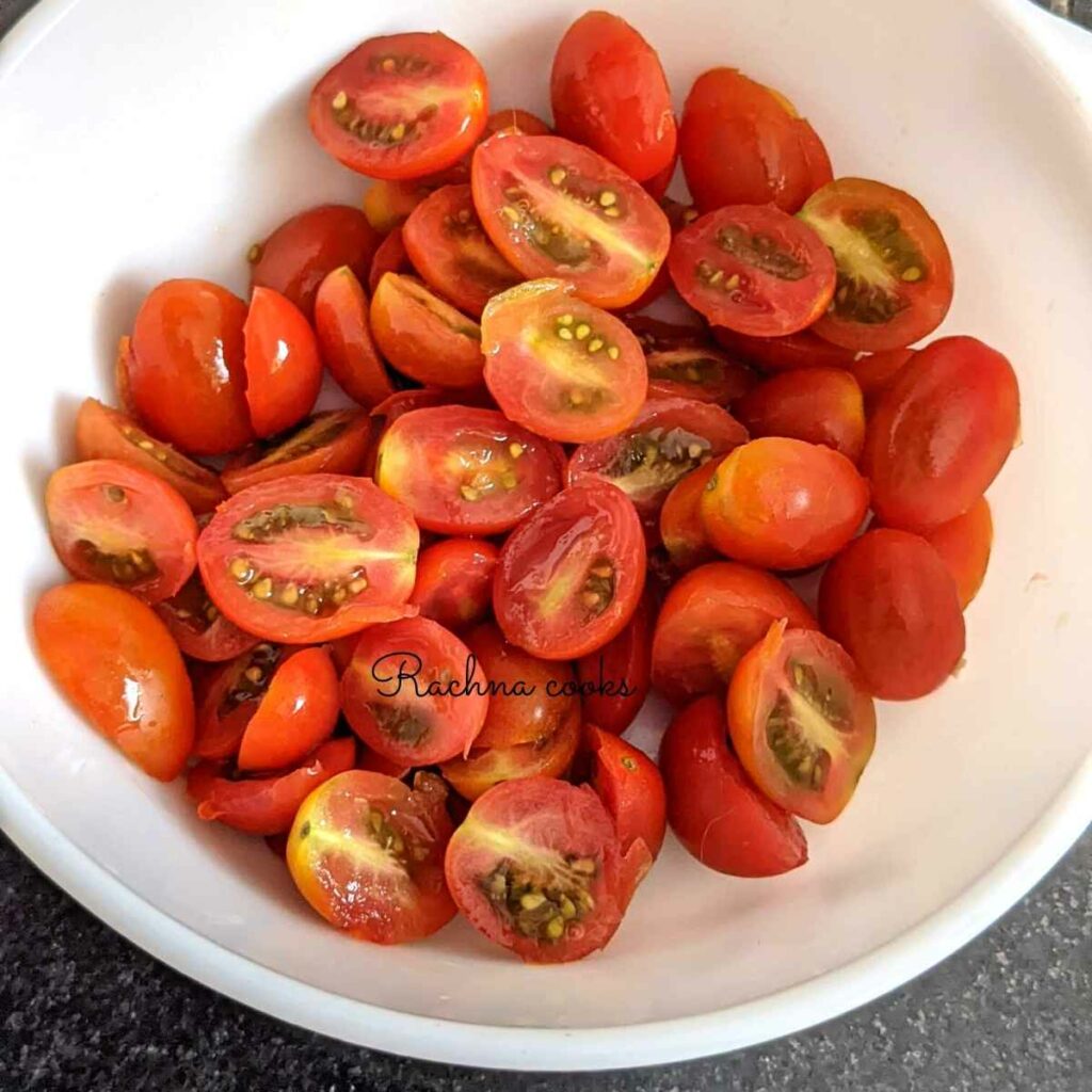 Cherry tomatoes cut in halves in a white bowl