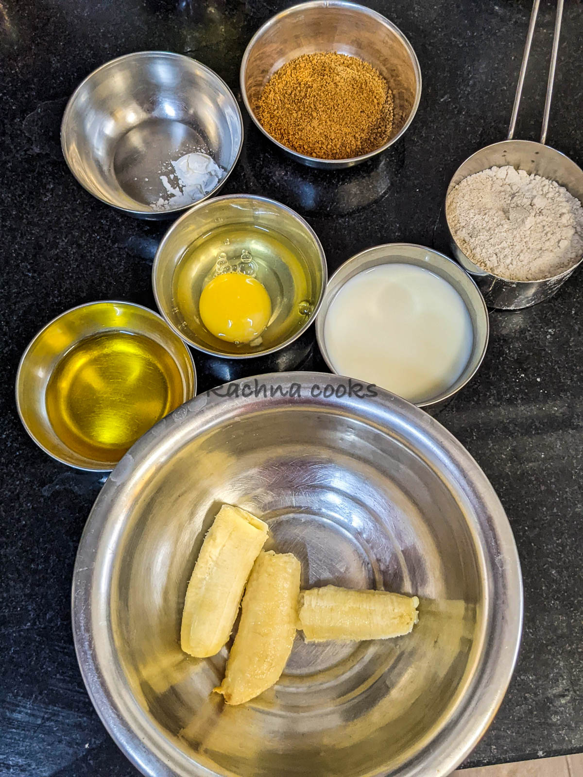 Ingredients to make banana bread are kept in bowls.