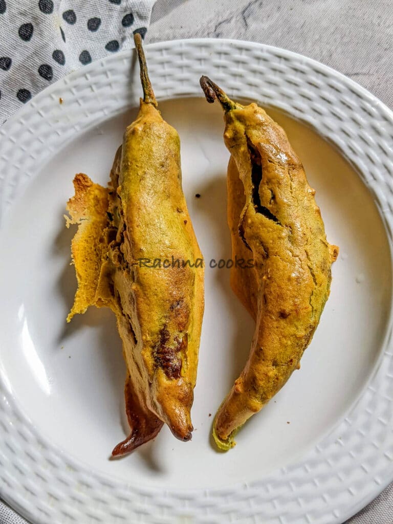 Two mirchi bhajjis air fried and on a white plate