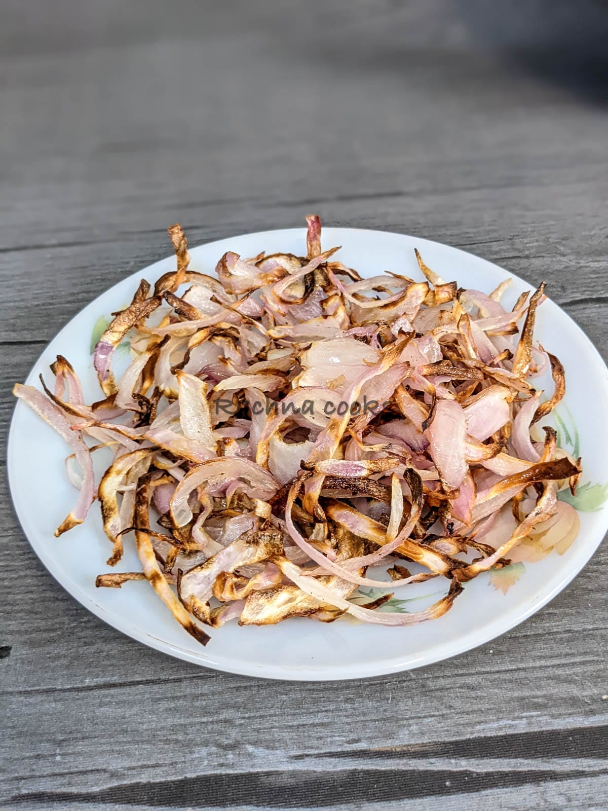 A top slide view of caramelized onions on a white plate.