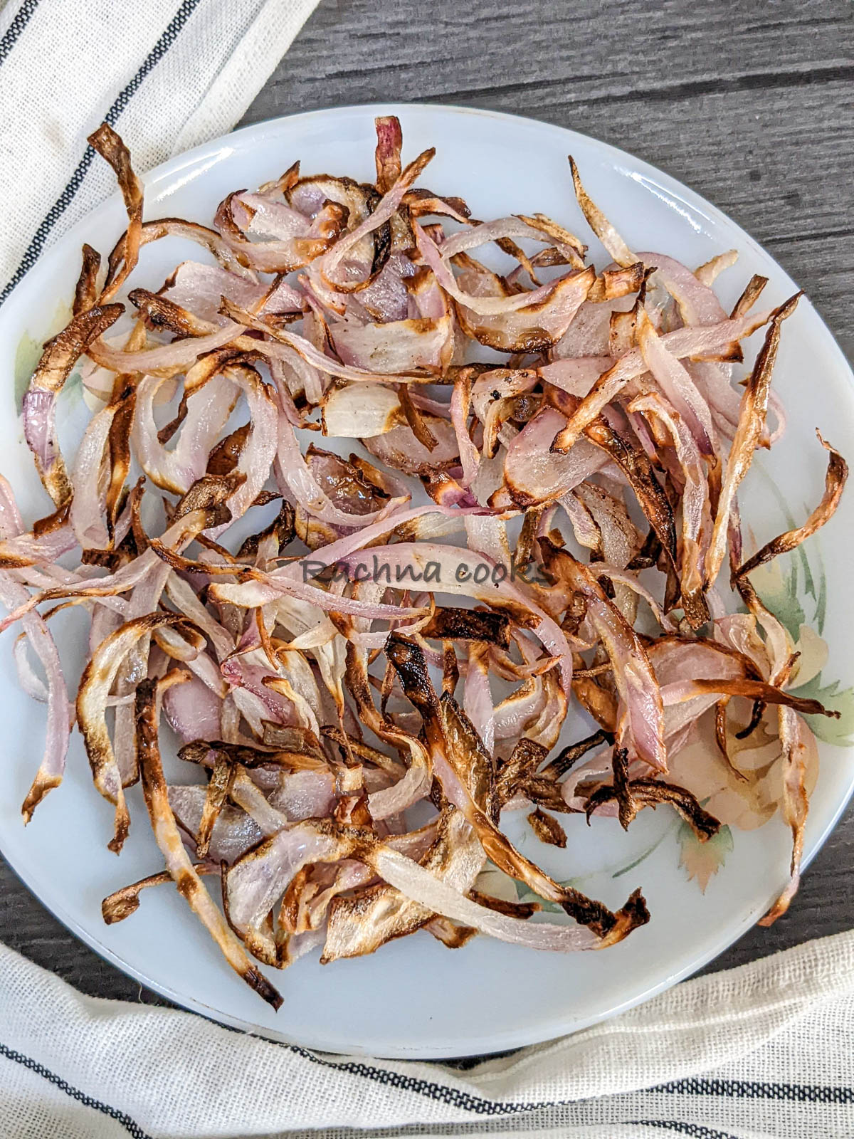 Close up of delicious caramelized onions on a white plate.
