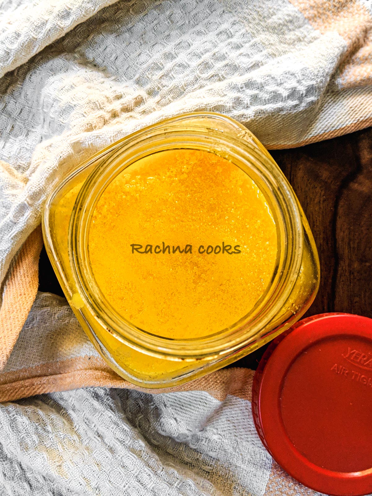 Top shot of golden ghee in a glass bottle.