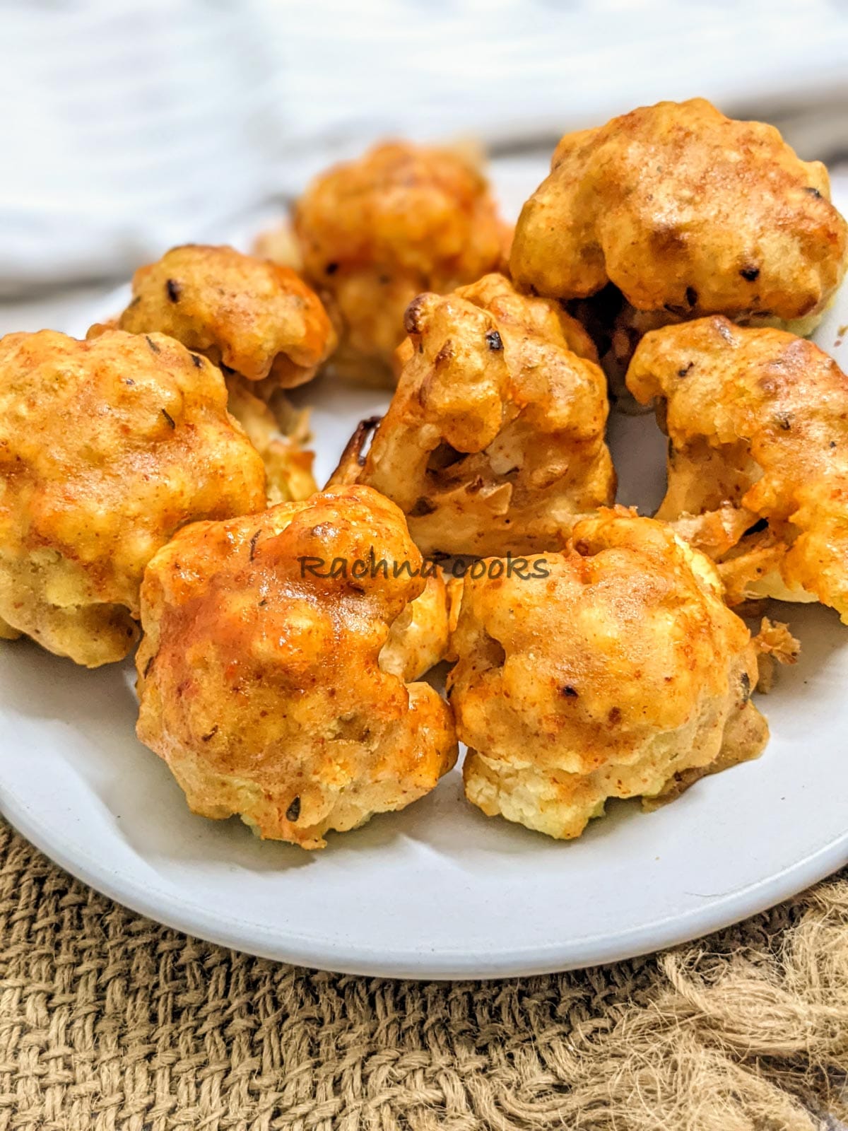 Close up of air fryer cauliflower wings after air frying on a white plate.
