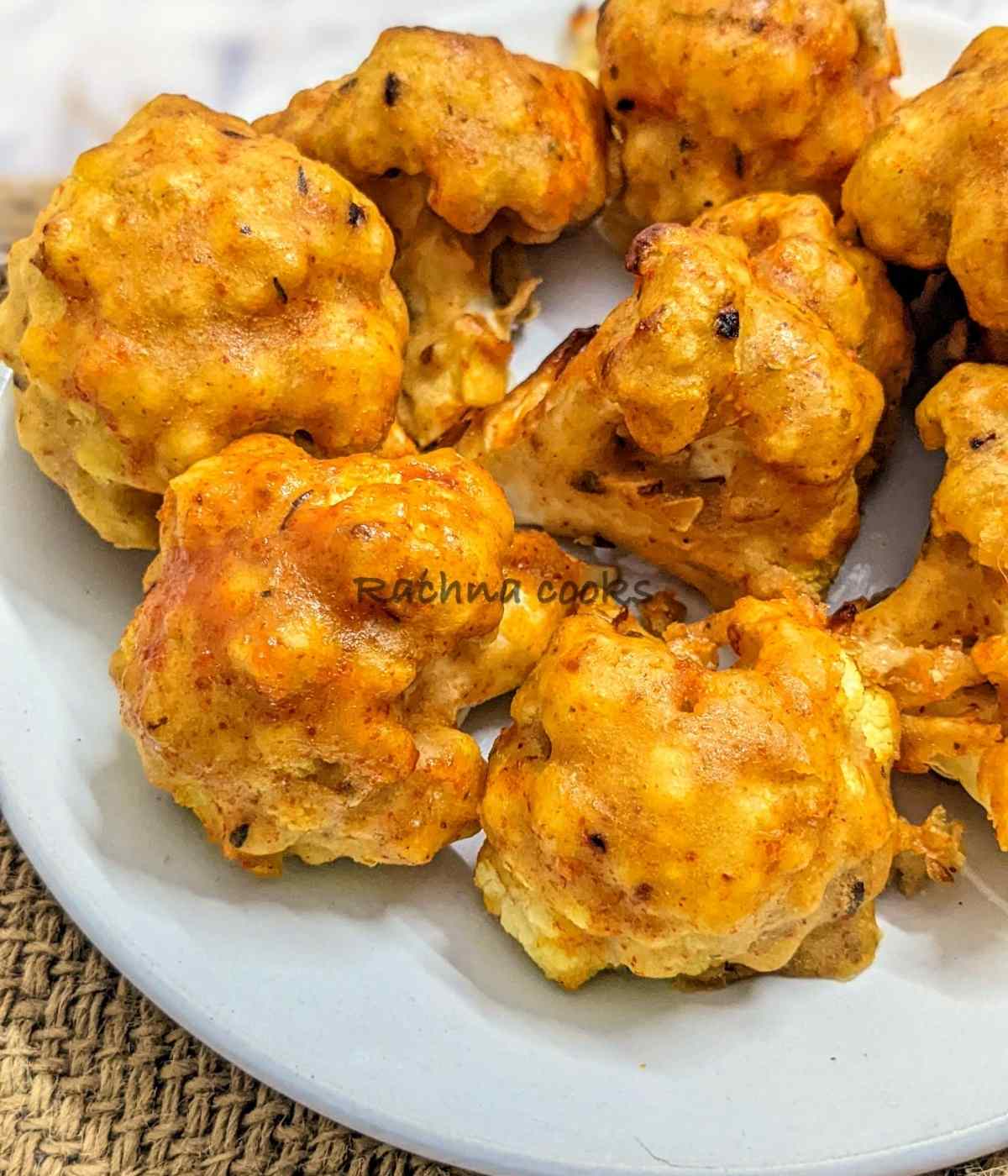 Close up of air fryer cauliflower wings after air frying on a white plate.