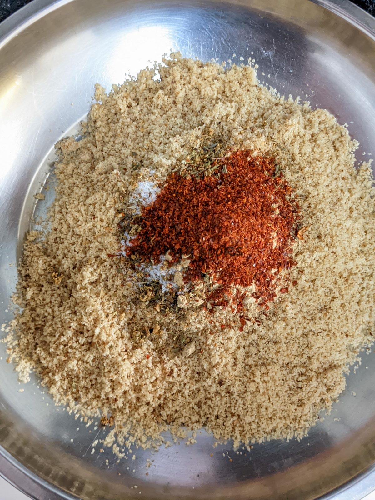Breadcrumbs with seasonings and spices in a shallow bowl