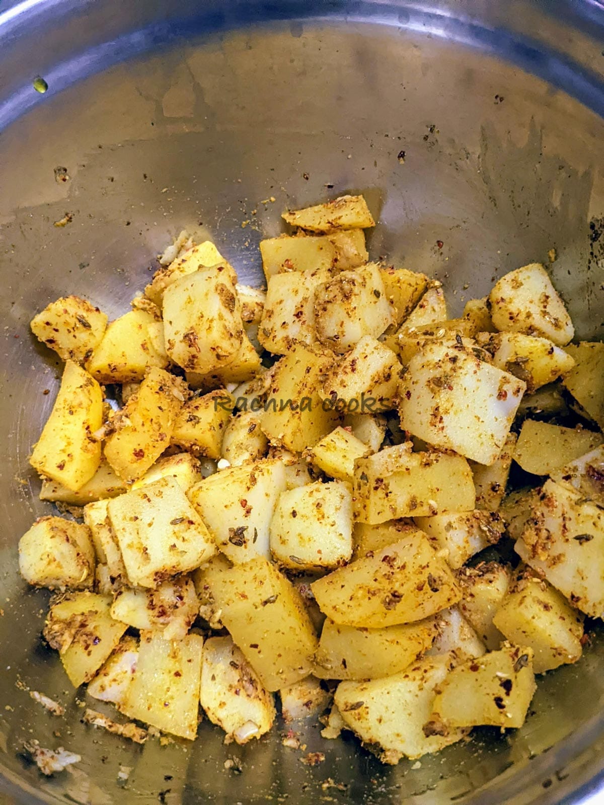 Boiled potato cubes with spices and oil