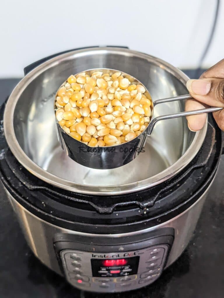 ½ cup unpopped corn being added to Instant pot that has oil.